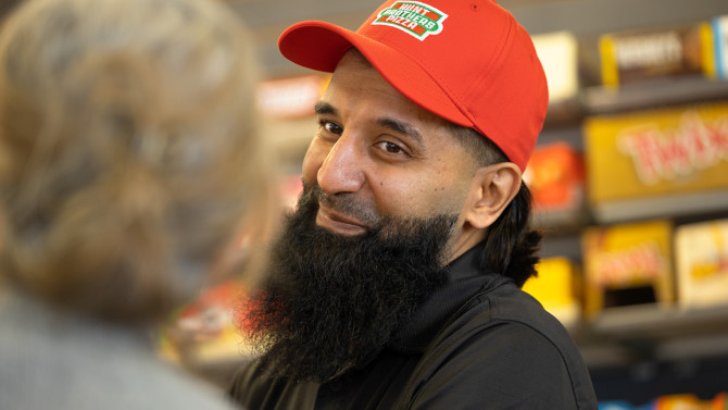 Rocky Mohamed, owner of Buffalo's Golden Corner store, talks with a customer. He and his family have run the store for 27 years and now participate in CCE Erie's Healthy Community Store Initiative.