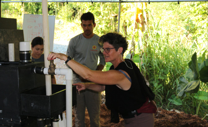 professor turns knob on filtration system