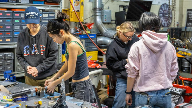Members of Cornell Racing, a student project team that designs, builds and races formula-style cars, work in the team’s Upson Hall garage.