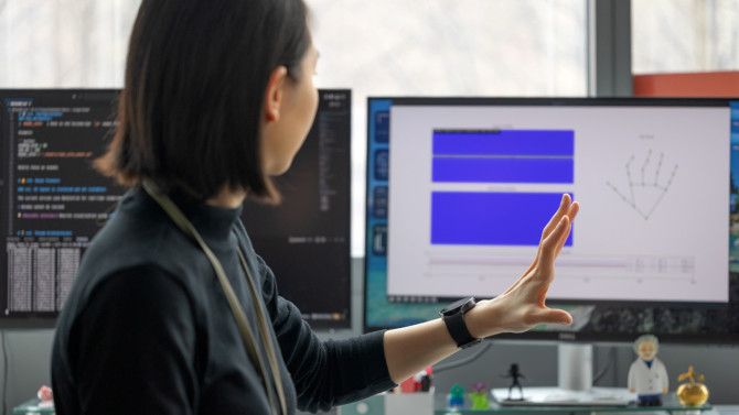 Doctoral student Chi-Jung Lee demonstrates the WatchHand device, which potentially could allow people to move screens on their computers without a mouse or tracking pad.