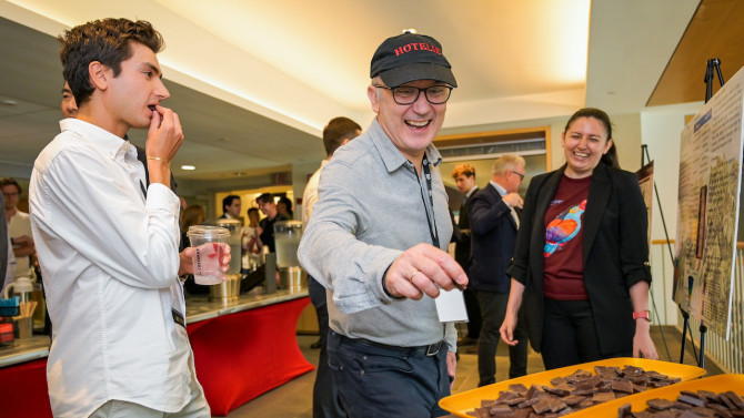 A Nolan School alum samples Better Tales chocolate.