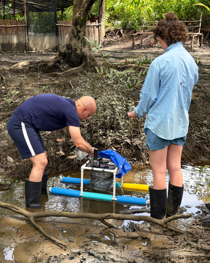 Researchers position monitoring equipment.