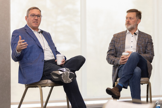 two people talking on a stage