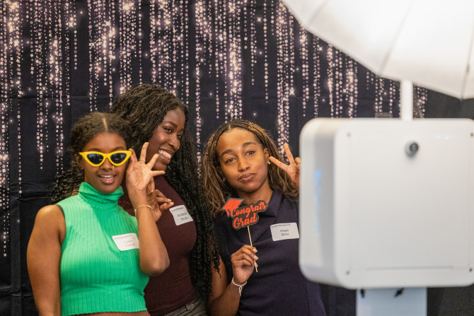 three students pose for camera