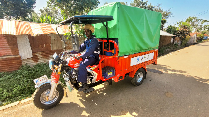 Jeremiah Ochieng doing the rounds, collecting containers of human excreta for processing into fertilizer at KIYA.