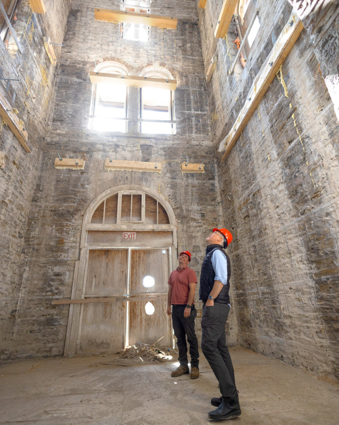 Heisler and Loewen view the inside of the structure. The project has reached the phase where interior rebuilding is underway following demolition.