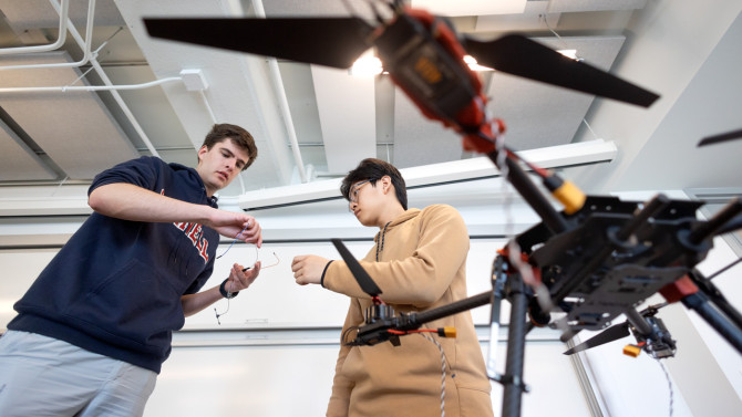 Alex Ilacqua, ’27, (left) a computer science major in the College of Arts and Sciences and the Cornell Ann S. Bowers College of Computing and Information Sciences, and Jeffrey Wang ’27, a mechanical engineering major in Duffield Engineering, work on their drone project during the Internet of Things and Technology and Engagement class.
