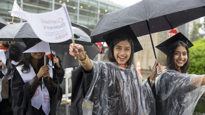 Graduates posing in rain