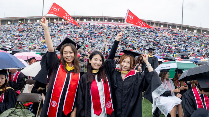 Graduates waving flags