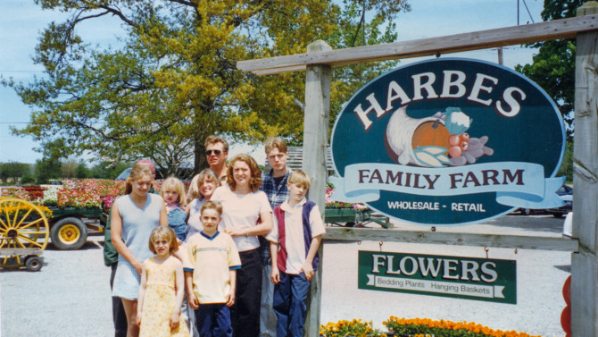 Edward III (top center) and Monica Harbes (middle) and their children outside the family farm in 1995.