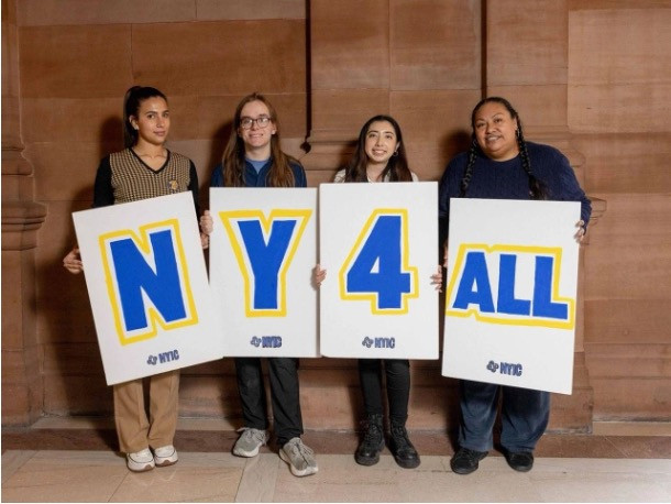 : Left to right: Maria Santa (person 1), Anezka Rodriguez (person 3) alongside immigrant rights advocates in Albany.
