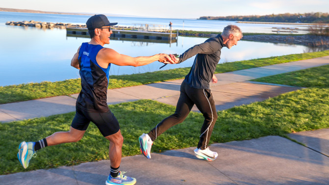 Aaron King, a doctoral student in the field of psychology, passes a prototype of the baton off to Peter Frazier, the Eleanor and Howard Morgan Professor of operations research and information engineering in Duffield Engineering. Their relay team tested the baton as they competed in the Seneca7 race on April 26 and provided feedback to the student designers.