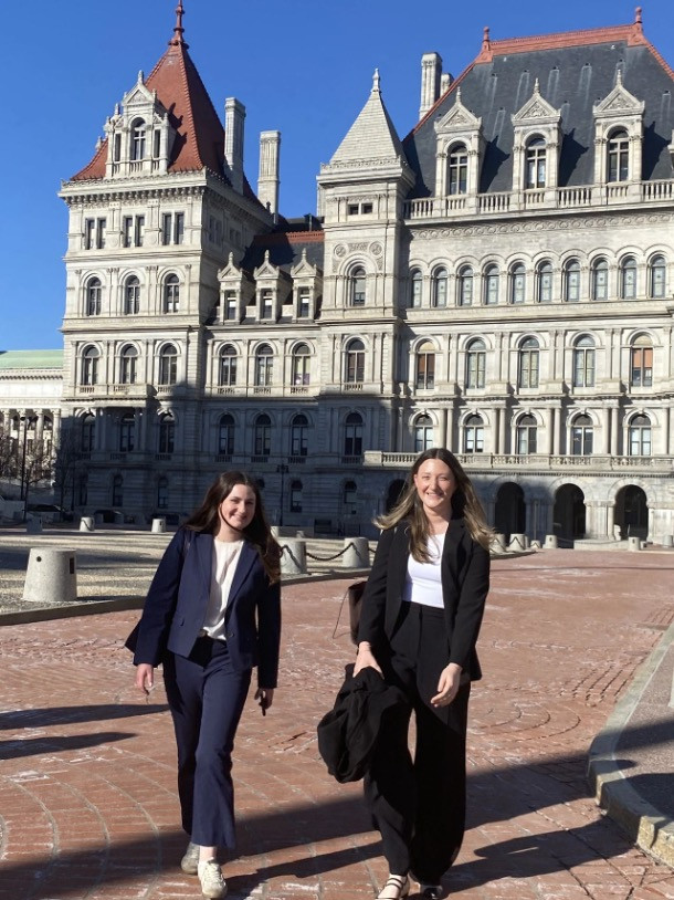 Emily Melcer (left), Emily Kolodner (right)  walking in fron of the NYS Capitol Building