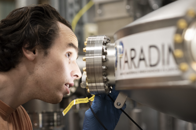 researchers looks through a lab device