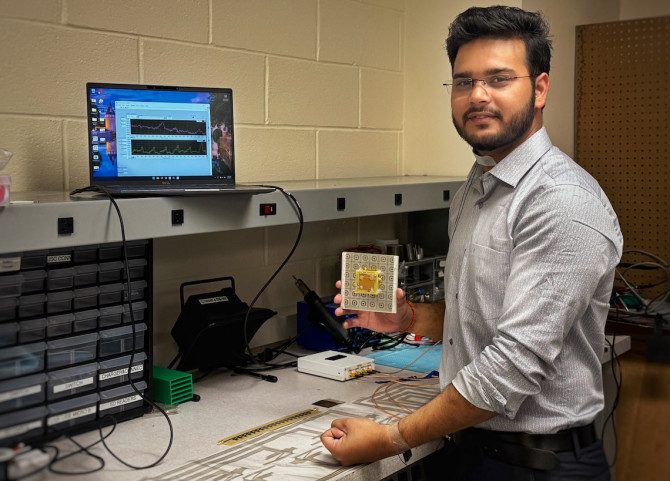 researcher hold device at workbench