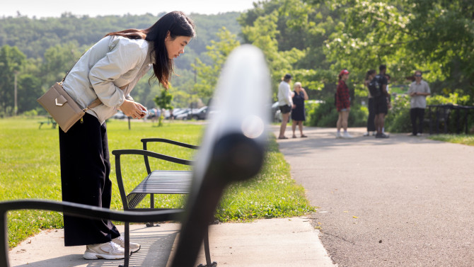 Ziwei Dong, master's student in landscape architecture, takes inventory of features in Stewart Park on July 1.