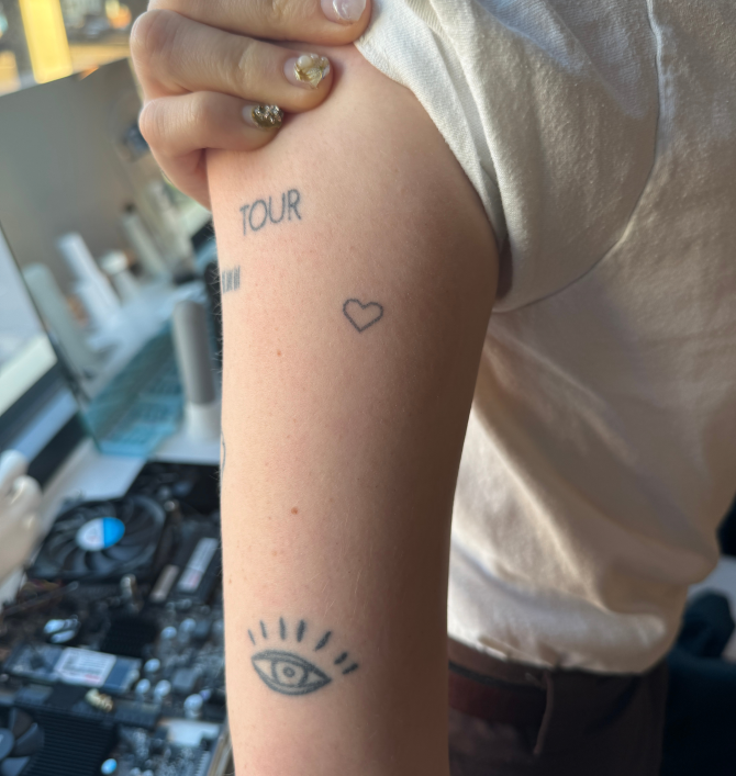 person's arm with tattoos