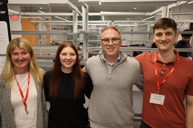 three alumni and a professor