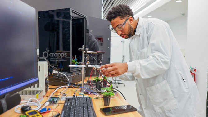 Undergraduate researcher Braddy Maria sets up the mobile demonstration unit “CROPPS in a Box.”