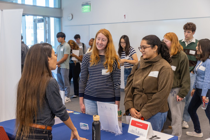 two people talking to another person at a career fair