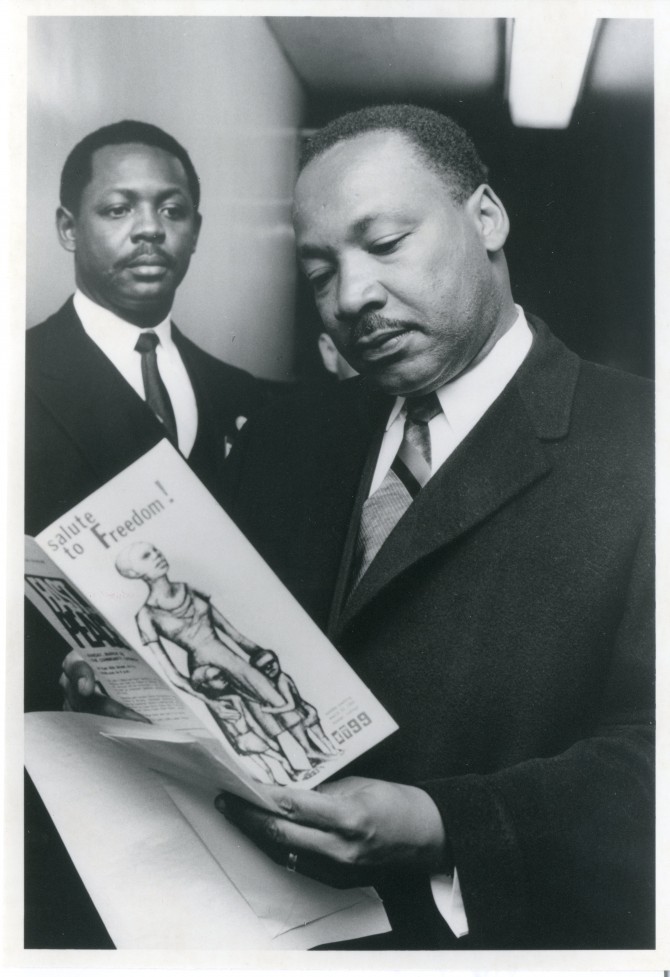Martin Luther King Jr. reading an 1199 pamphlet for "Salute to Freedom" 