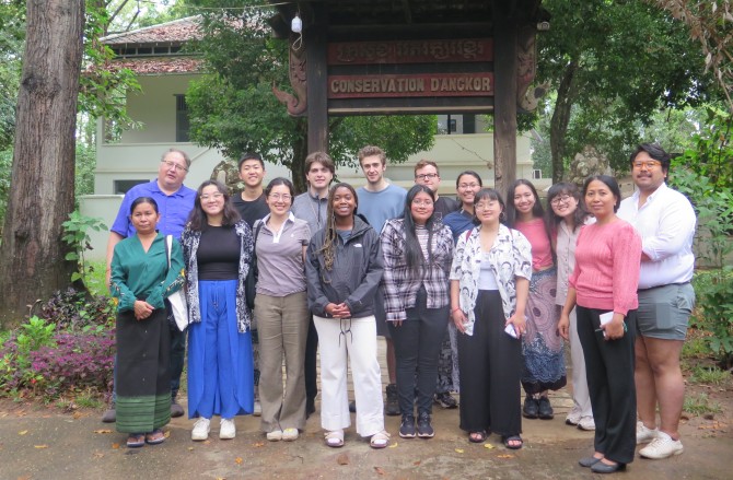 The group at Angkor Conservation Center’s exterior gate with conservators Vannary Mam and Hang Chansophea. 