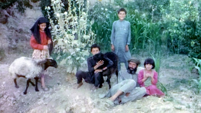 Farid Ferdows ’21 (center) stands with his family on their land in Logar, Afghanistan.