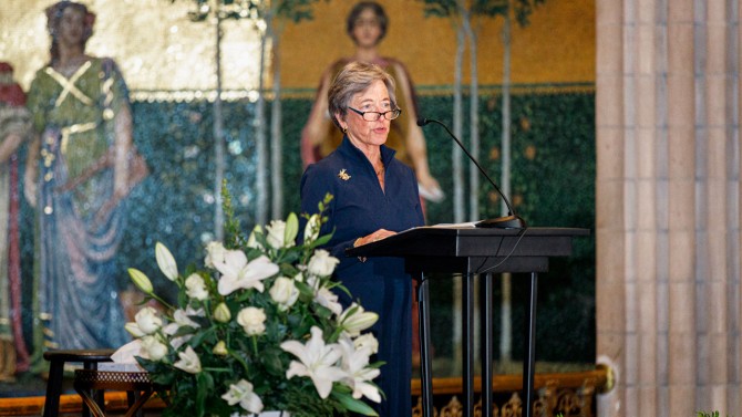 Woman speaks at the podium of a church.