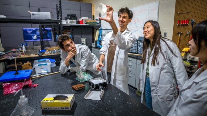 Members of the Alpha CubeSat team – from left, João Maria de Mesquita ’20, doctoral student Joshua Umansky-Castro, Stephanie Young ’23 and Siqi Qian ’21 – look at a hologram that features a sculpture created by Ithaca-born artist C Bangs.