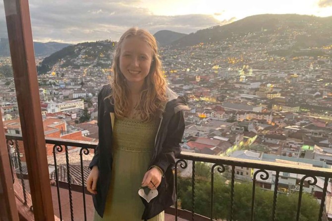 Hannah Drexler stands outside a restaurant overlooking the city of Quito, Ecuador.