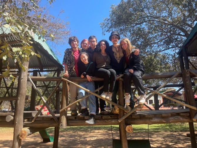 Lia Sokol and other Laidlaw scholars pose for a photo at a playground in Zambia.