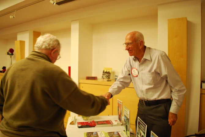 Robert Kahrs shaking hands with a Reunion attendee in 2014