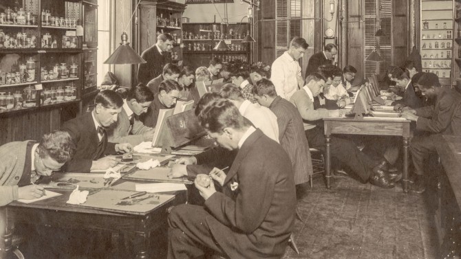 A historical photo of students working in a lab.