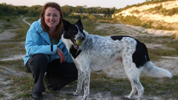 Dr. Sarah Caddy with a black and white dog