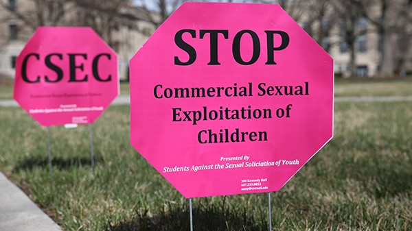 Sign on the Cornell ag quad that says Stop Commercial Sexual Exploitation of Children