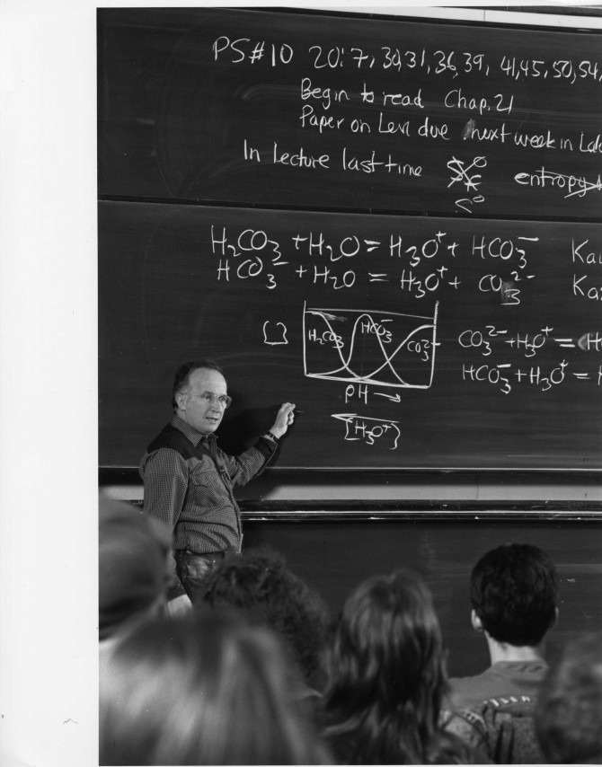 Roald Hoffmann teachings physics in front of a chalkboard filled with complex equations