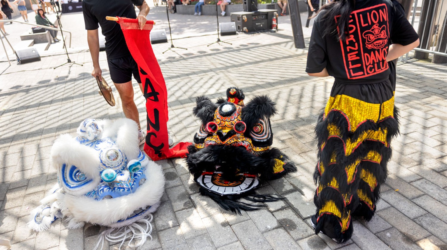 Members of the Cornell Lion Dance prepare for their performance at the Bernie Milton Pavillion on the Commons.