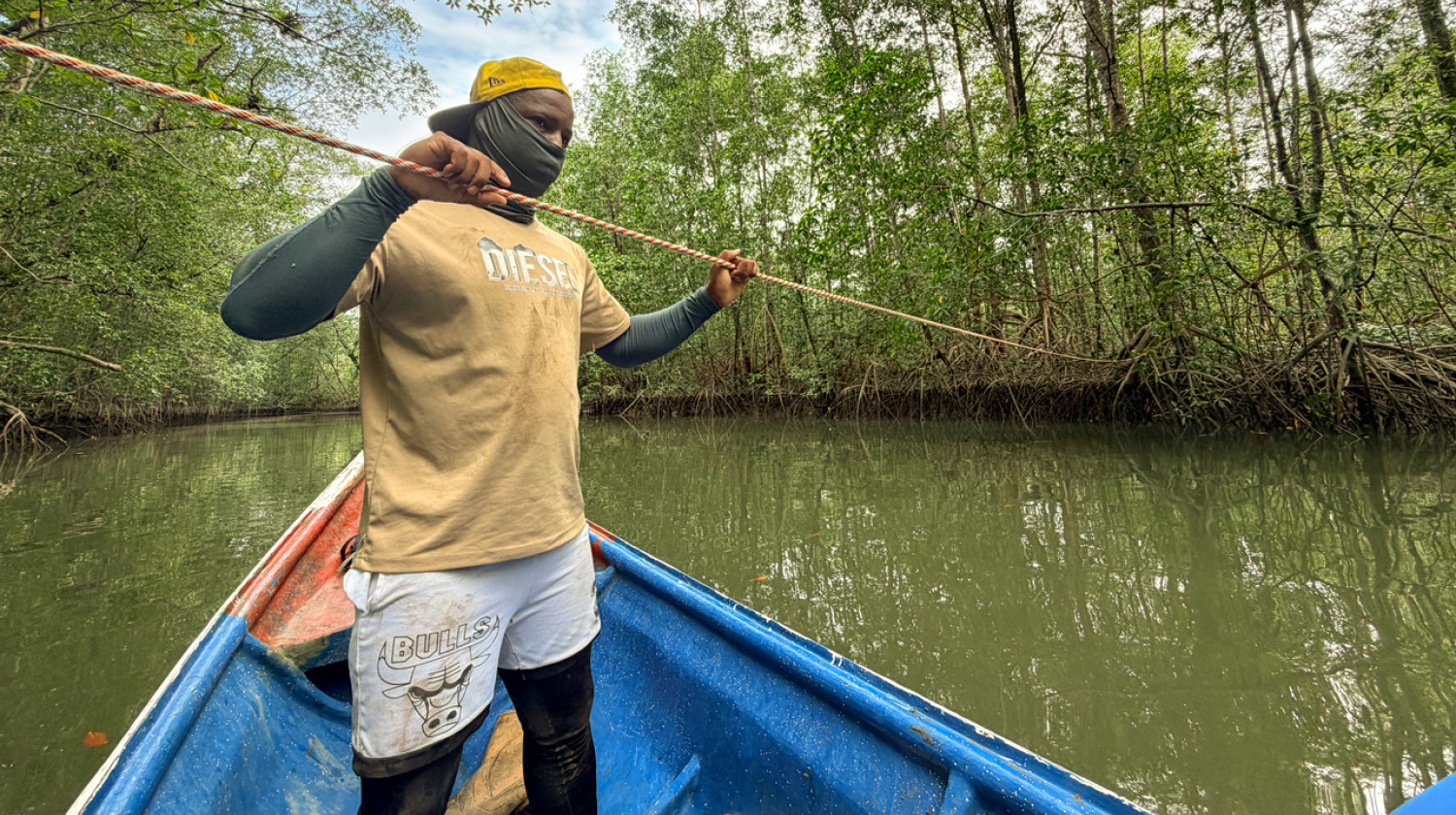 Community members and researchers work together to position monitoring equipment in challenging coastal conditions.