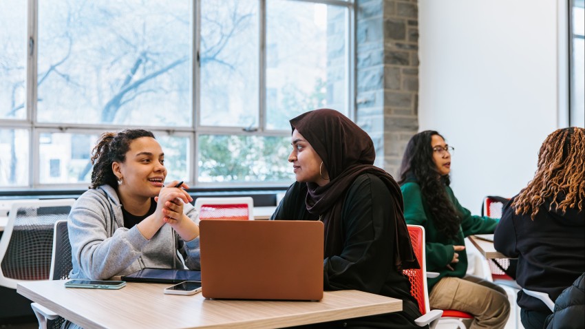 two students sit at table