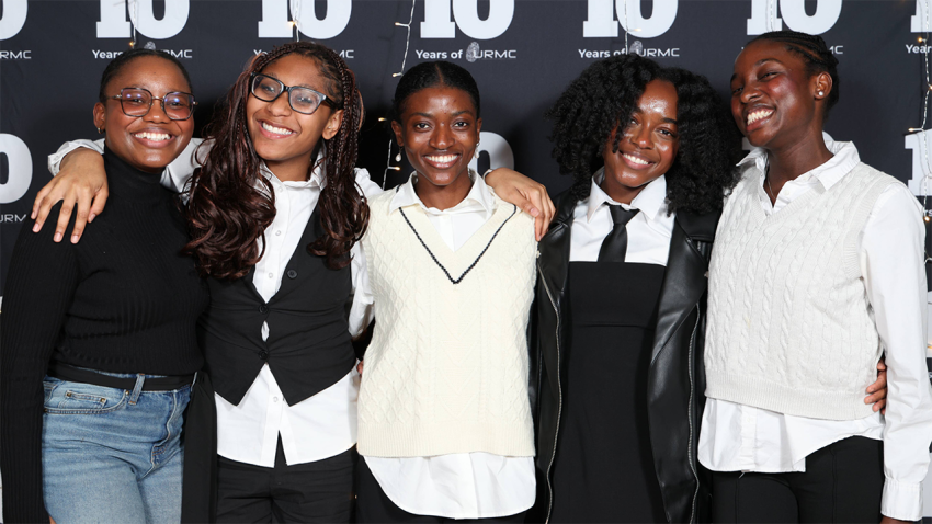 Five students of color pose for a photo