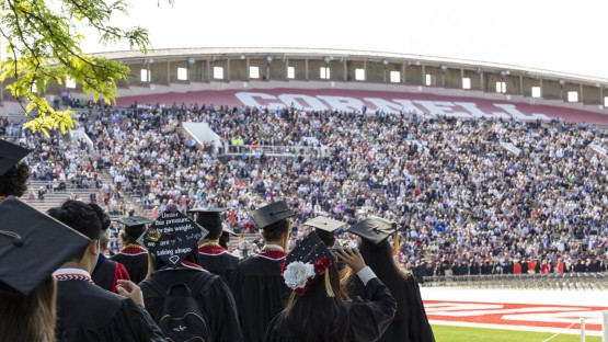 Graduates and their families celebrate together during the 2023 Commencement ceremony at Schoellkopf Field.