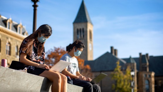Students study an the top of Libe Slope on a warm afternoon.