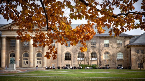 Students take advantage of the outdoor tables in front of Goldwin Smith Hall.