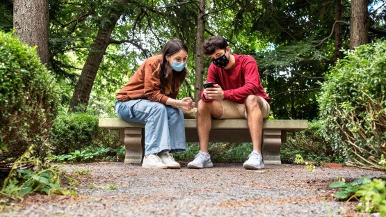 Students sit near the Rockwell Azalea Garden.