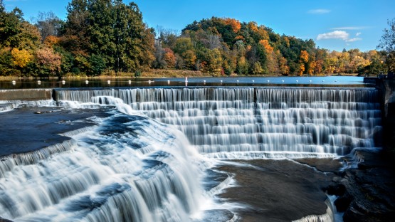 Water flows over Triphammer Falls.
