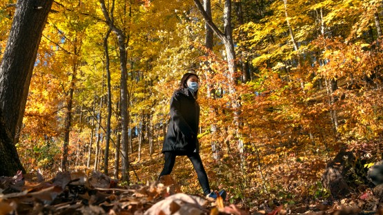 A student walks in the Beebe Lake natural area.
