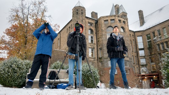 Students look for birds on Libe Slope.