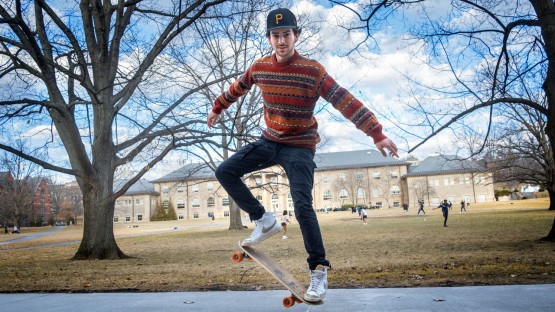 A student skates on the Arts Quad.