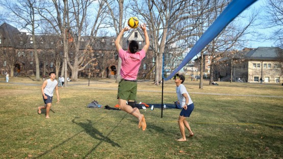 Friends take advantage of a warm day to play volleyball on the Arts Quad.
