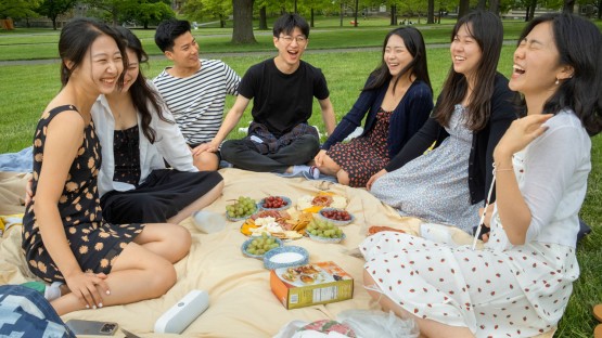 A group of friends picnic on the Arts Quad.
